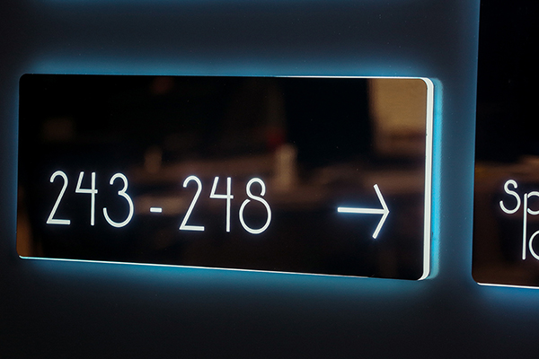 illuminated, stainless steel directional sign